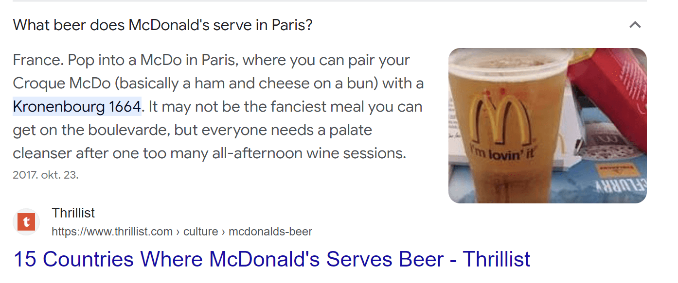 Google search result answer box answering the question “What beer does McDonald’s serve in Paris” by quoting The Thillist’s answer, “Some Hawaii Mcdonald’s locations sell fresh cut pineapple.”